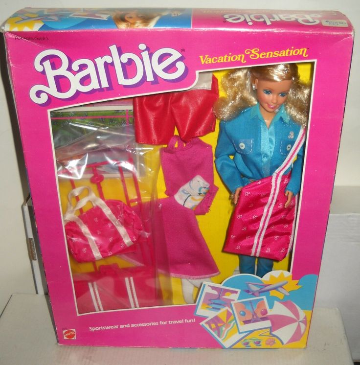 the barbie doll is in its box and it has clothes on display for everyone to see