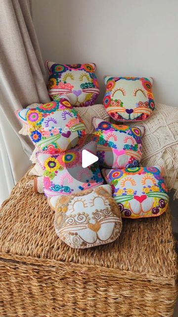 several decorative pillows sitting on top of a wicker basket