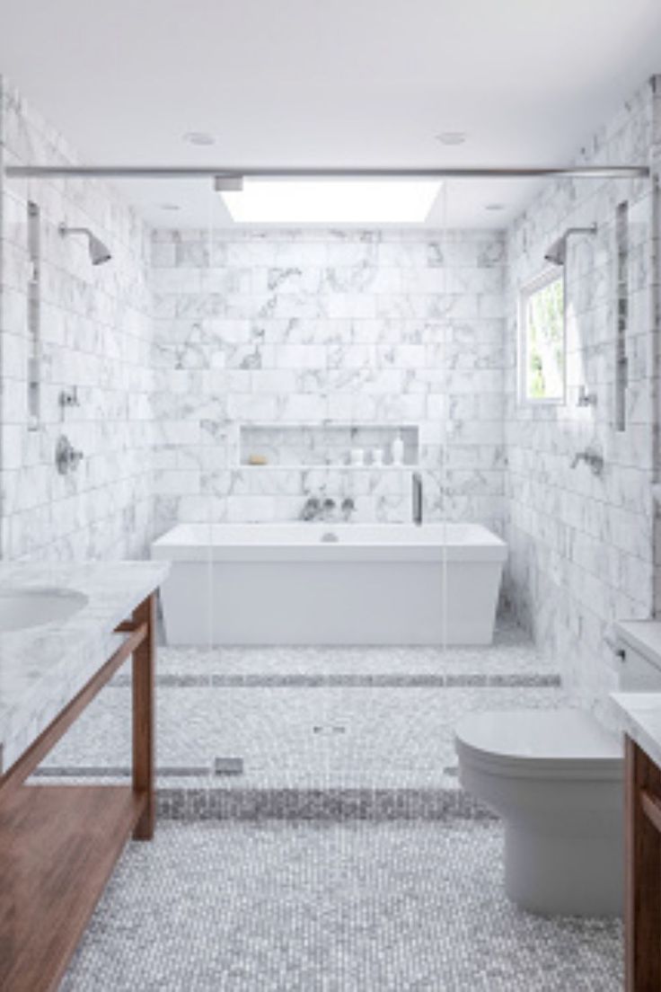 a bathroom with white marble walls and floors