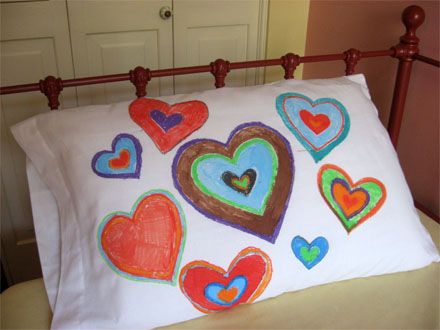 a pillow with hearts on it sitting on a bed