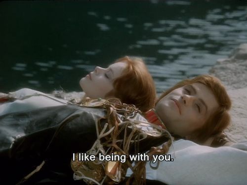 two women laying next to each other on top of a body of water with the caption i like being with you