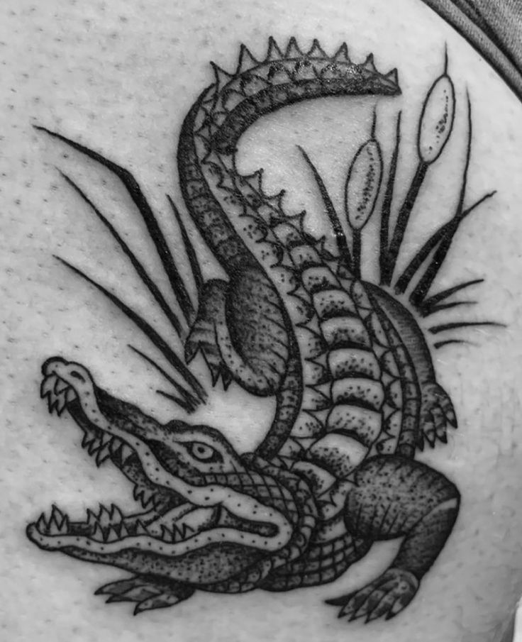 a black and white photo of a dragon tattoo