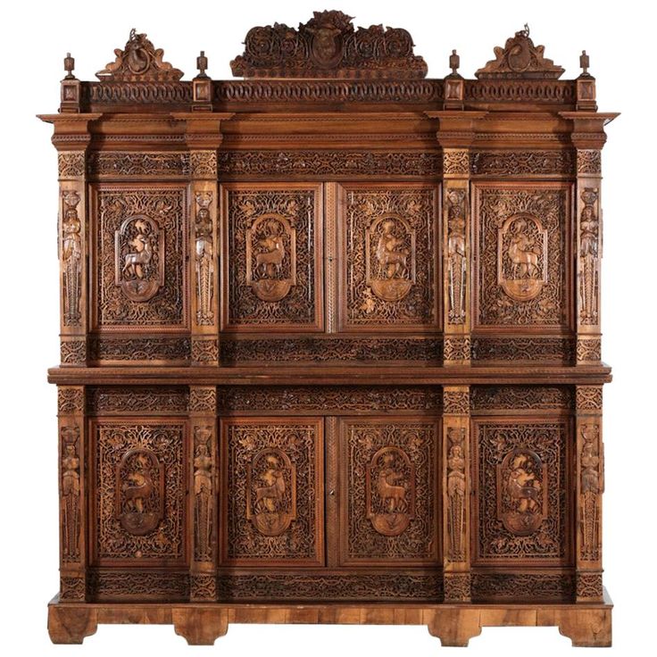 an intricately carved wooden shelf with carvings on it