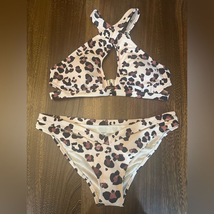 Adore Me Leopard Print Bikini. Brand New With Tags And Protective Plastic Sticker On Bottoms. Details Bikini Set Nylon/Spandex/Polyester Removable Pads Cross-Front Neckline With Center Keyhole Keyhole Details On Sides Of Cups Adjustable Back Straps Hook And Four Adjuster Back-Loop Closures Matching V-Front Bikini Bottom With Keyhole Details At Waist Fabric: 85% Nylon, 15% Spandex Lining: 100% Polyester Fitted Beige Halter Neck Swimwear, Fitted Cream Swimwear For Swimming, Fitted Beige Swimwear For Beach Party, Fitted Cream Swimwear For Pool, Summer Beige Halter Neck Swimwear, Fitted Cream Swimwear For The Pool, Beige Halter Neck Summer Swimwear, Cream Sleeveless Swimwear For Beach, Fitted Summer Swimwear In Cream