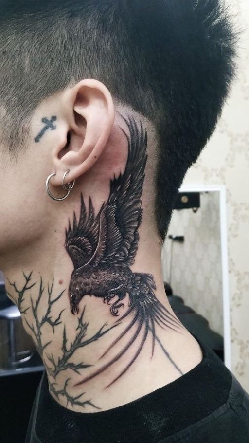 a man with a tattoo on his neck has an eagle and cross behind the ear