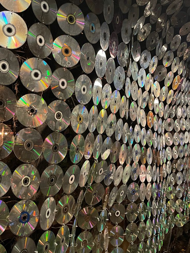 several rows of cds are lined up on the wall