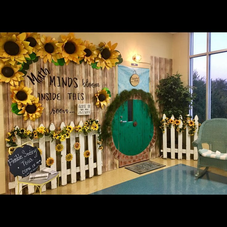 a classroom decorated with sunflowers and a green door