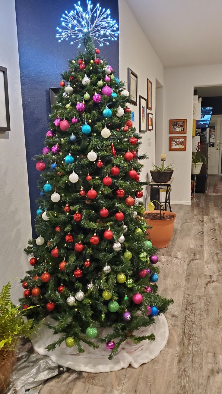 a decorated christmas tree in the middle of a room