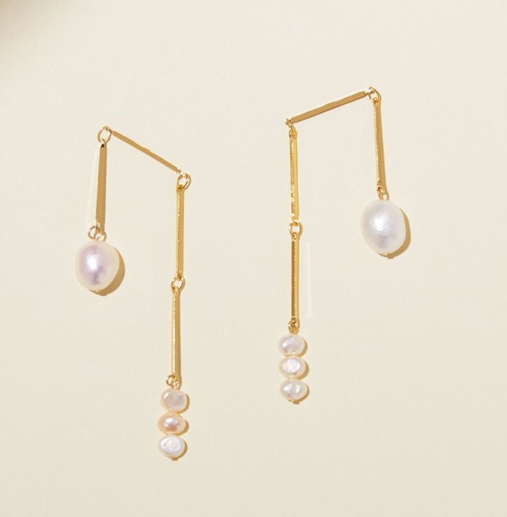 Something a little different! These asymmetrical dangling beauties have lots of movement, are lightweight, and make statement without being too big. Materials: Gold plated brass, sterling posts and backs, and freshwater pearls. These earrings are 2” long After testing these over and over we found they stay balanced and in place when the ear backs are snugly attached. if you find they are moving, just tighten the backs a bit more. We also use comfortable, extra large backs to help keep them secur Candle Studio, Rings Mens Wedding Bands, Bow Arrows, Pop Bottles, Wedding Rings Vintage, Engagement Ring Wedding Band, Mens Wedding Rings, Mens Wedding Bands, Antique Rings