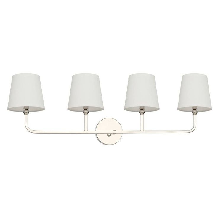 four light bathroom fixture with white shades on the side and two lamps on the front