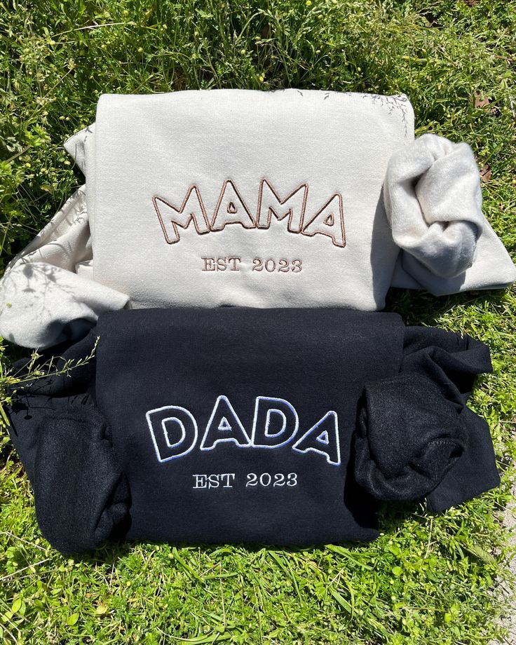 two personalized bags sitting on the grass in front of each other, one for dad and another for daughter