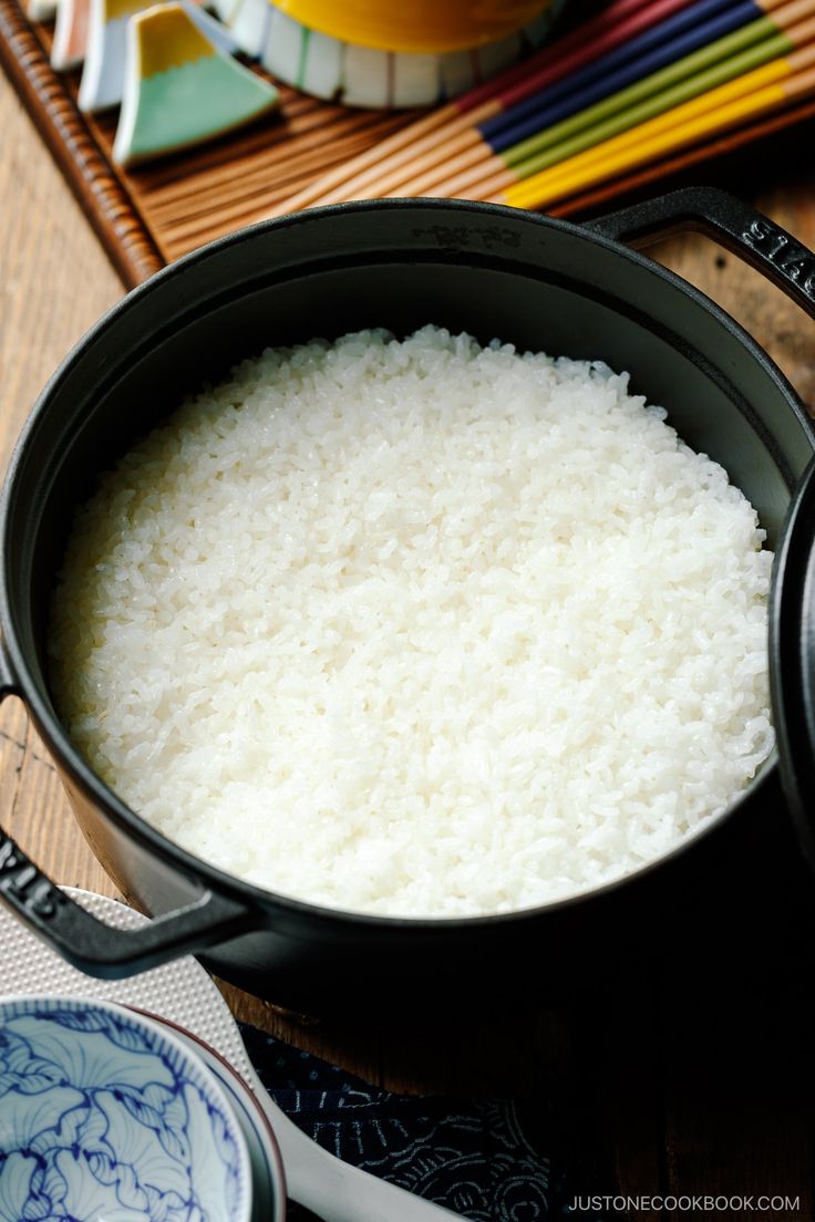 rice is cooked in a pot on the table