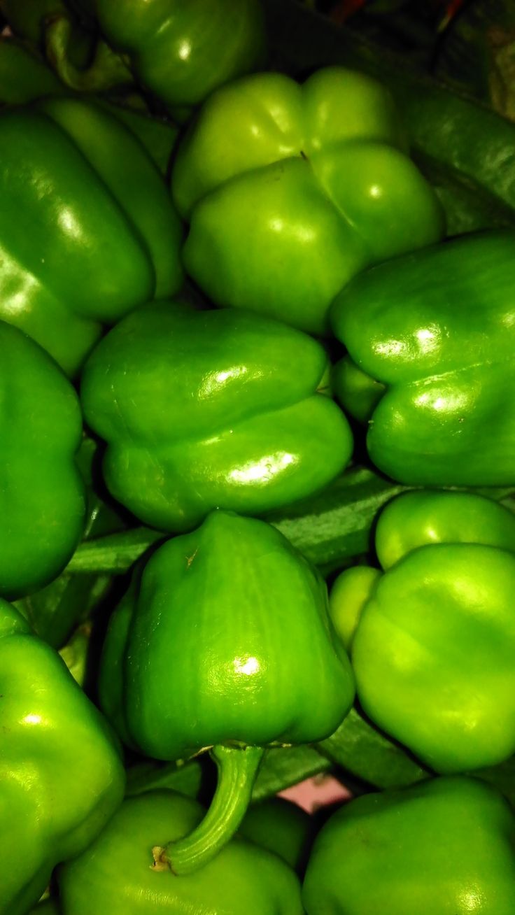 green peppers are piled on top of each other