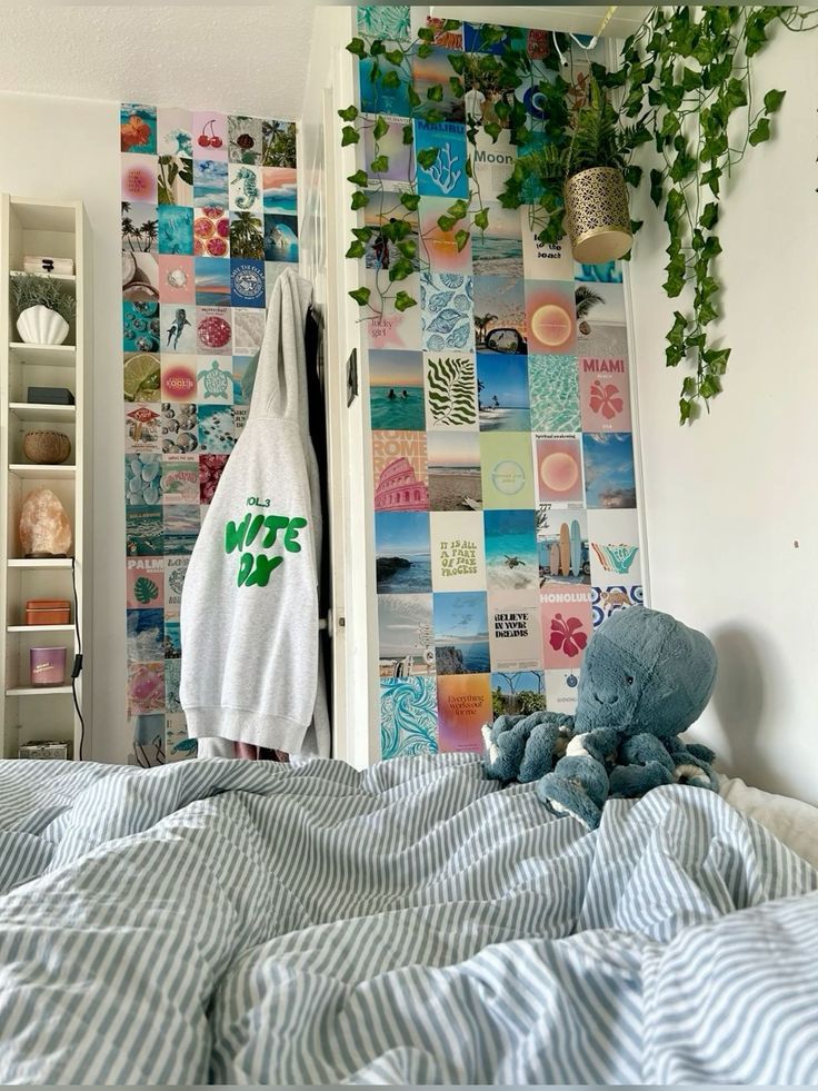 a stuffed animal sitting on top of a bed next to a wall covered in pictures