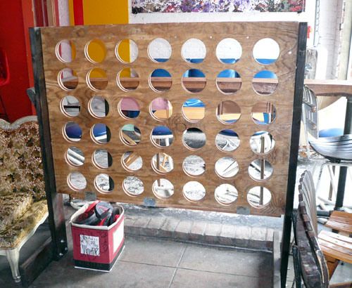 a room divider made out of wood and mirrors