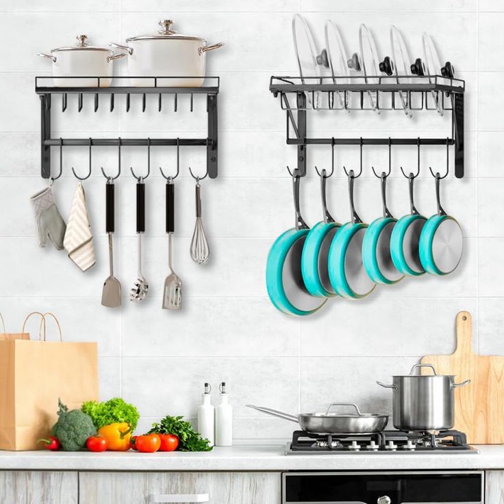 there are many pots and pans hanging on the wall above the kitchen counter top