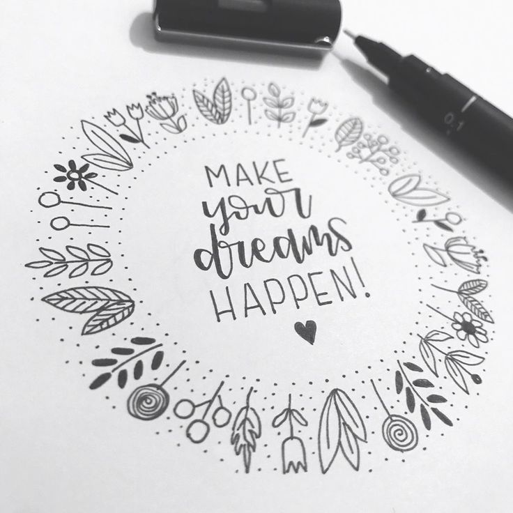 the words make your dreams happen written in a circle surrounded by doodles and markers