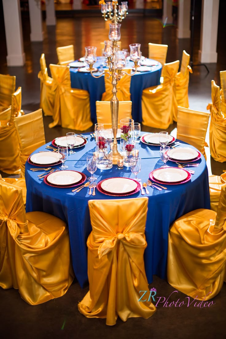 the table is set with blue and yellow linens