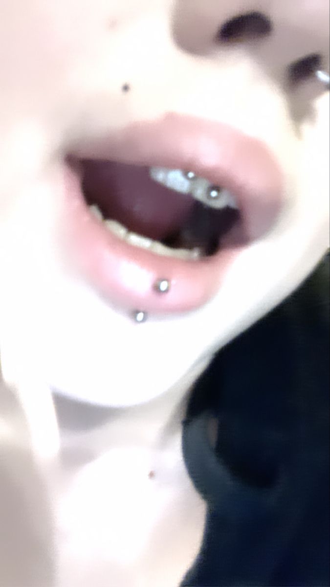 a woman with piercings on her tongue