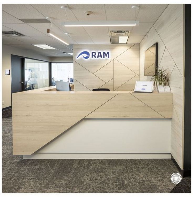 the front desk of an office with a sign on it that says ram in blue