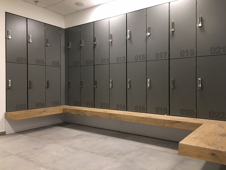 lockers are lined up against the wall in an empty room