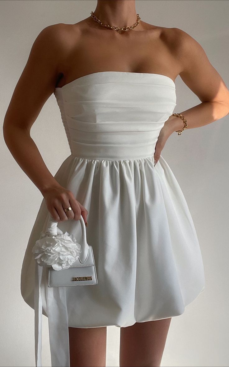 Shaima Mini Dress - Strapless Dress in White | Showpo USA Graduation Dress Strapless, White Grad Dresses High School, Classy Graduation Dresses, Bubble Mini Dress, Satin Strapless Dress With Bow, Dress For Graduation Day, White Graduation Outfit, Strapless Short Dresses, Grad Party Dresses