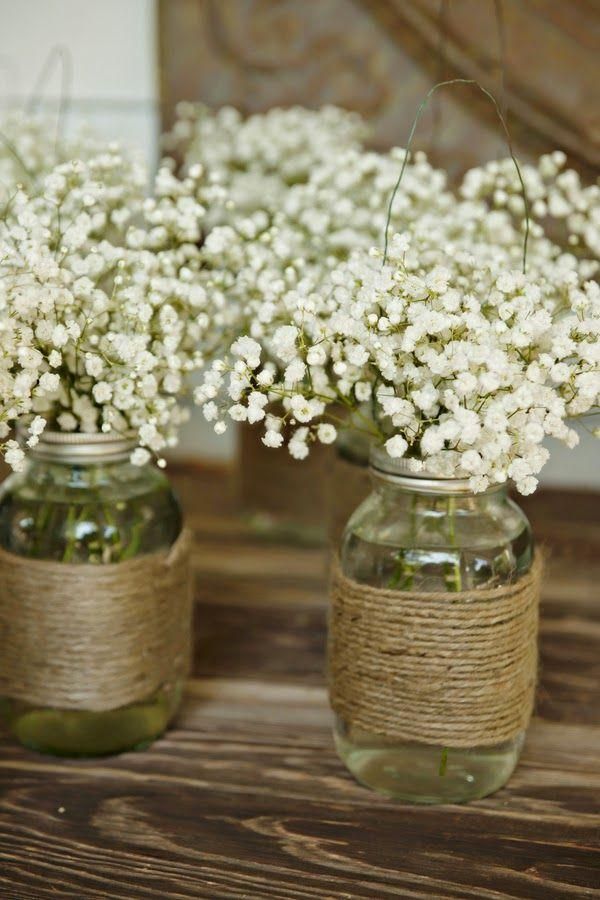 three mason jars filled with baby's breath flowers