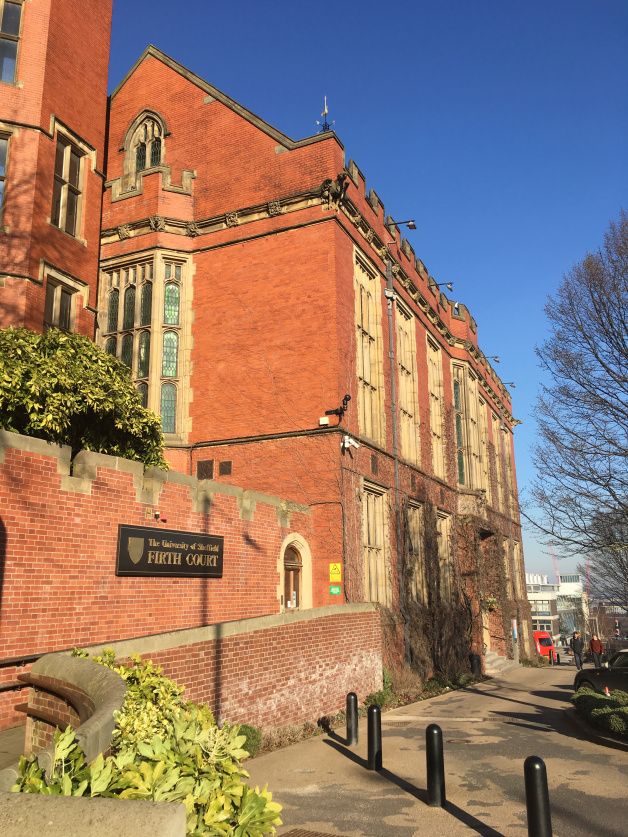 an old red brick building on the corner of a street