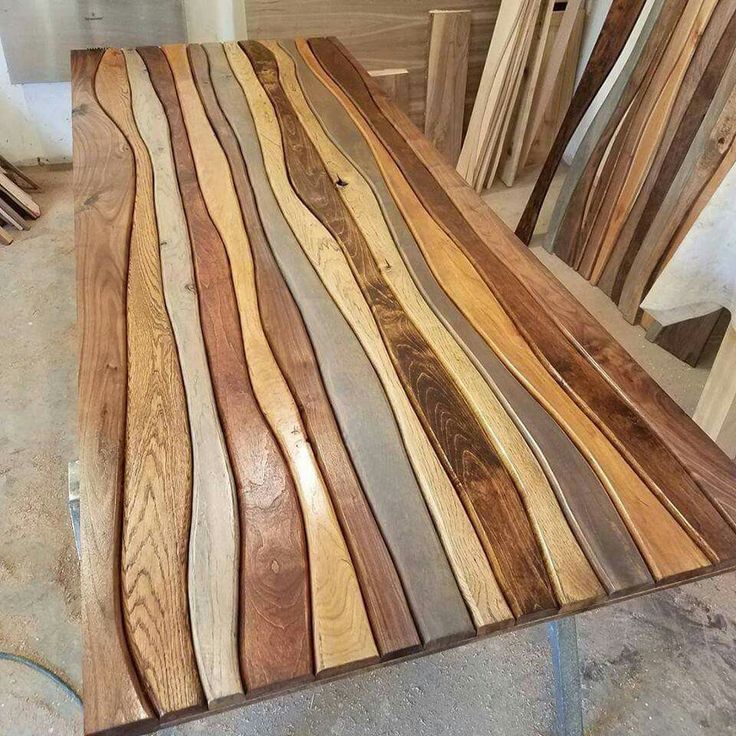 the table is made out of wood and has different colored stripes on it, as well as two chairs