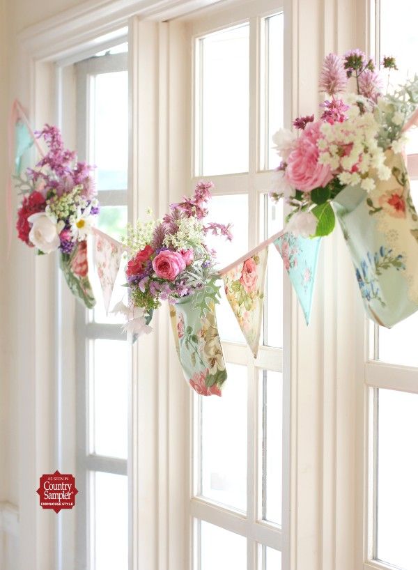 some flowers are hanging from a window sill