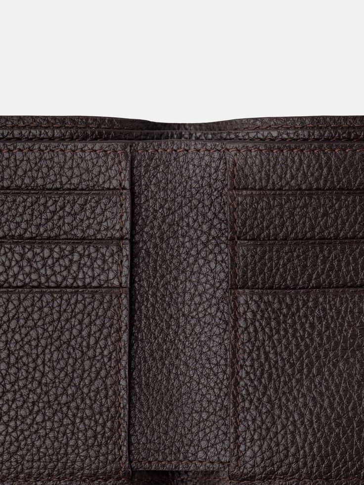 Developed to house all the essentials, The Wallet in brown grain features a sleek, understated folded design with two full-width compartments for notes and six card slots. The supple, grained leather adds a smooth touch that guarantees it will age gracefully, developing a beautiful patina as it joins you in your everyday life.   The Wallet is handmade in Ubrique, Spain. Luxury Leather Wallet With Grained Texture, Formal Leather Wallet With Grained Texture, Classic Brown Card Holder With Leather Lining, Classic Textured Leather Wallet For Business, Textured Leather Bifold Wallet For Business, Business Leather Trifold Wallet With Card Slots, Brown Bifold Wallet For Business, Luxury Brown Trifold Wallet For Daily Use, Classic Textured Leather Business Wallet