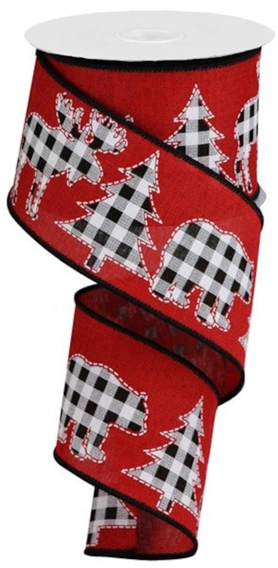 a red ribbon with black and white plaid animals on it, in the shape of an arrow