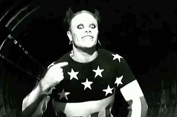 a man wearing an american flag shirt with stars on it's chest and pointing to the side