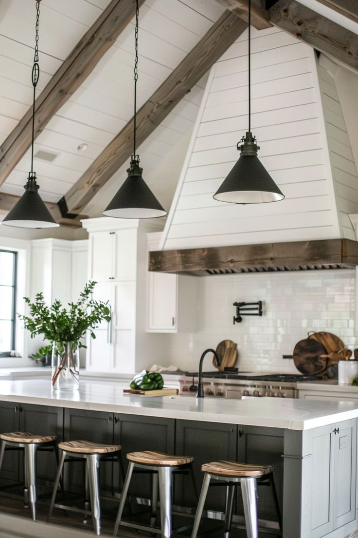 a kitchen with an island and stools in it