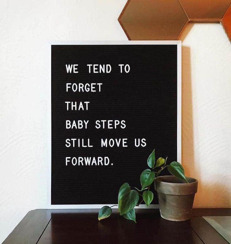 a black and white sign with the words we tend to forget that baby steps still move us forward