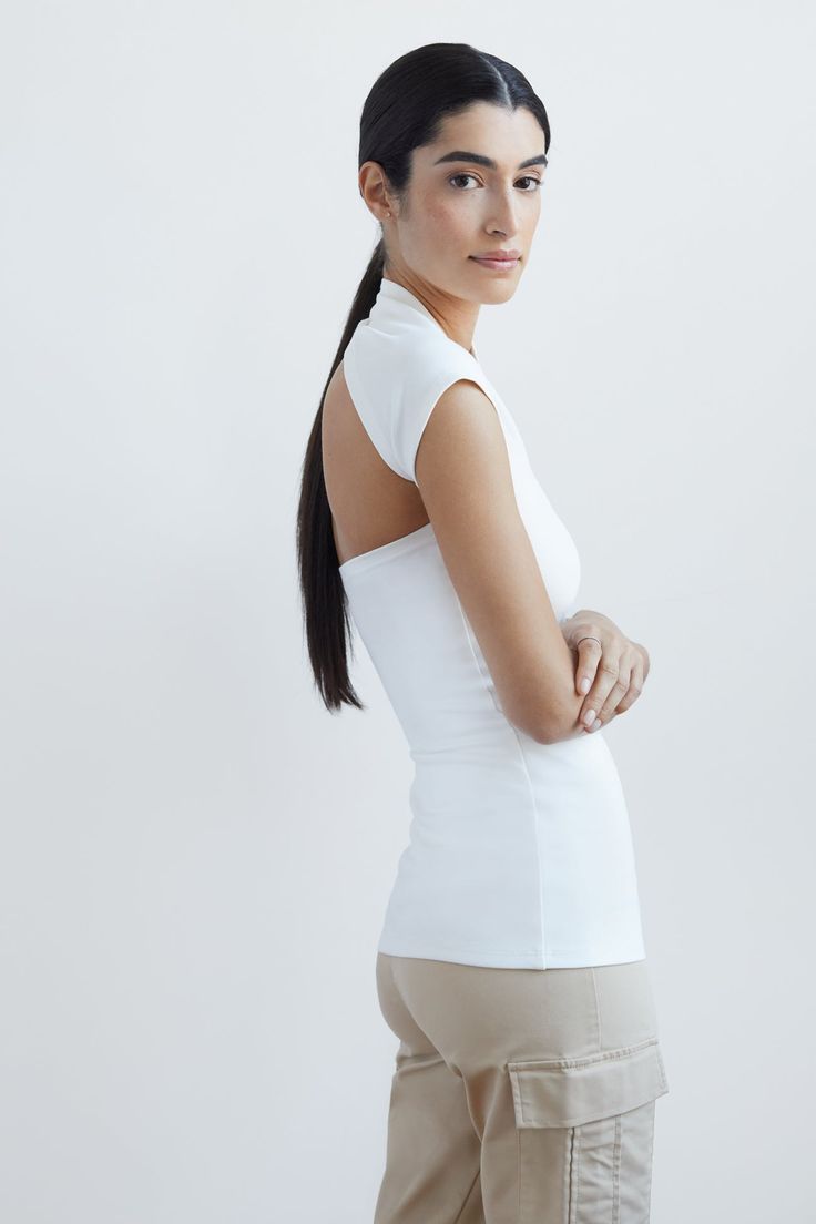 For when a sleeve just won't do...meet the airy version of our iconic bestseller, the Manhattan Sleeveless Top. She's designed with a sculpted one-shoulder neckline in wrap-around style, with one fitted cap sleeve. Crafted from soft, stretchy European ponte, our Manhattan Sleeveless Top has a comfy touch, making her all-day/all-night wearable. [SPLIT] Sam, in off white, is 5'8" (173 cm) tall, wearing size XS. Julia, in black, is 5'10" (178 cm) tall, wearing size XS. Total length is approximately Top Clothing, Cap Sleeve, Manhattan, Cap Sleeves, Best Sellers, Winter Outfits, Sleeveless Top, One Shoulder, Open Shoulder Tops