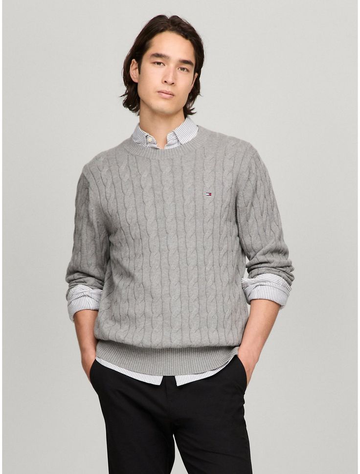 Tommy Hilfiger men's sweater. Made from soft cotton in a textured cable knit weave, this crewneck sweater is the perfect layer, complete with rib-knit cuffs, collar and hem with touches of subtle branding throughout.  Material: 100% Cotton. Classic Cotton Cable Knit Polo Sweater, Classic Cable Knit Polo Sweater, Classic Cotton Cable Knit Sweater, Classic Crew Knit Sweater, Classic Textured Knit Sweater, Classic Cable Knit Crew Neck Sweater, Tommy Hilfiger Sweater With Ribbed Cuffs For Fall, Tommy Hilfiger Fall Sweater With Ribbed Cuffs, Tommy Hilfiger Classic Crew Neck Sweater