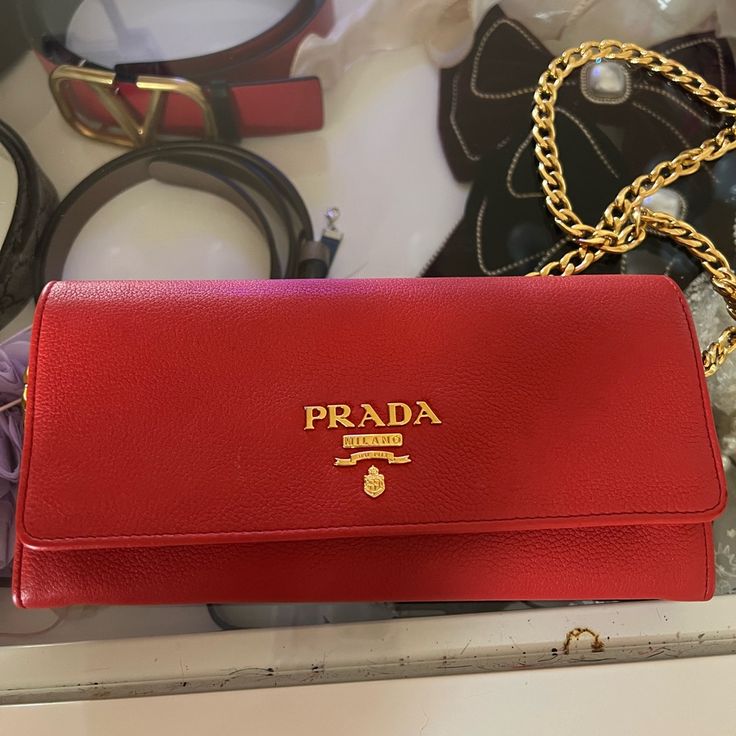 Like New Red Prada Bag Not A Single Scratch In Sight Very Very Gently Worn Comes With Red Chain, Red Wallet To Attract Money To Be Used As Wallet Or Crossbody Willing To Negotiate Send An Offer Luxury Red Clutch With Removable Pouch, Luxury Red Clutch Wallet, Designer Red Wallet For Travel, Luxury Red Wallet With Removable Pouch, Luxury Red Clutch With Gold-tone Hardware, Elegant Red Clutch With Dust Bag, Designer Red Evening Wallet, Red Luxury Wallet For Everyday Use, Classic Red Bag With Chain Strap