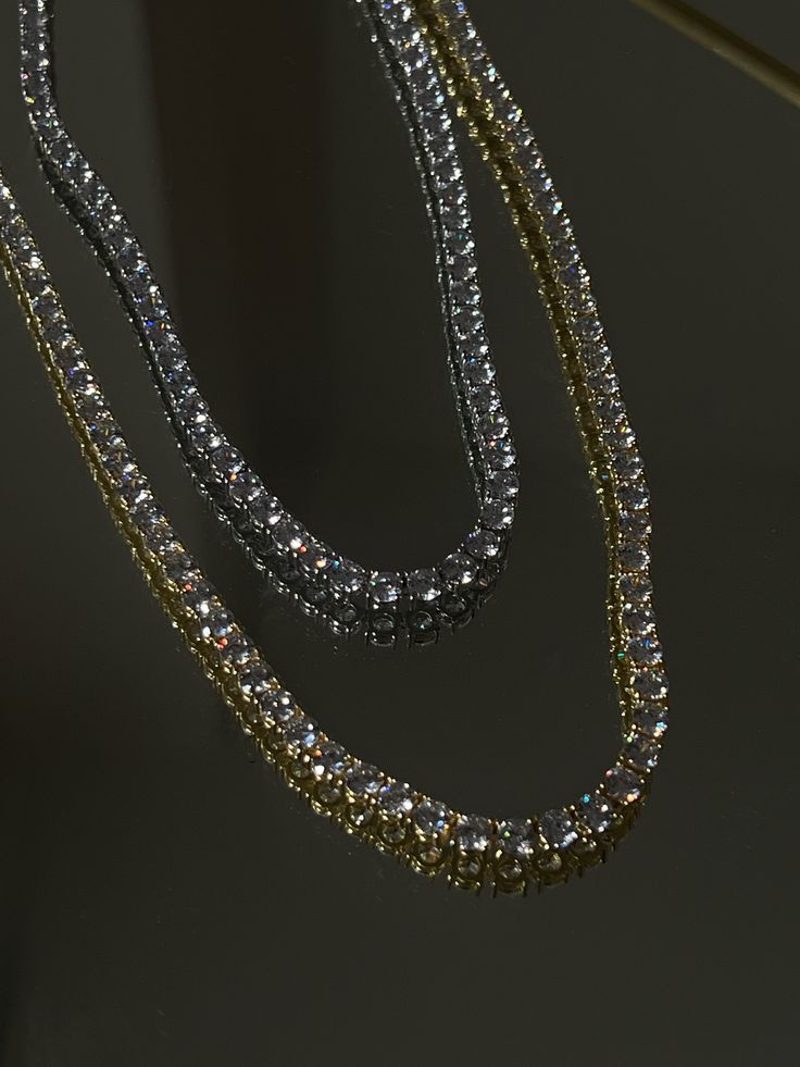 Classic CZ single strand tennis necklace Perfect for layering Available Lengths: 16" & 18" Stone size: 4MM Brass with silver and 14kt gold plating with CZ stones Phone Items, Tennis Necklace, Cz Stone, 14kt Gold, Gold Plating, Silver Necklaces, Silver Gold, Layering, Tennis