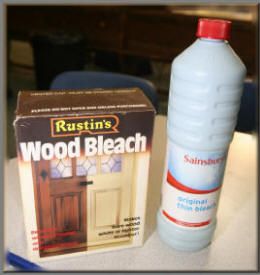 a bottle of wood bleach sitting next to a box of glue on a table