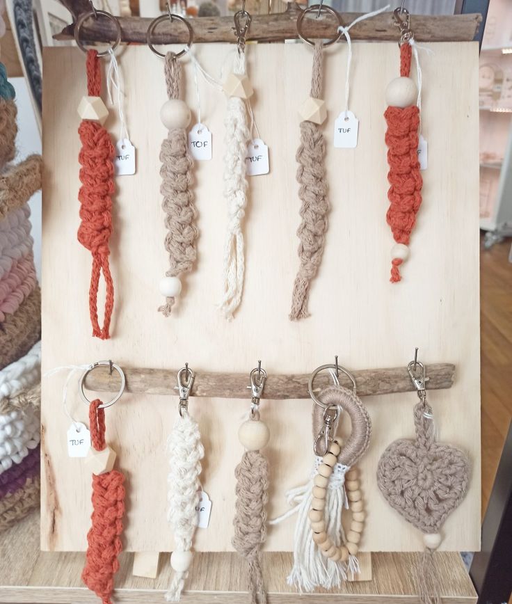 there are many crocheted key chains hanging on the wall next to each other