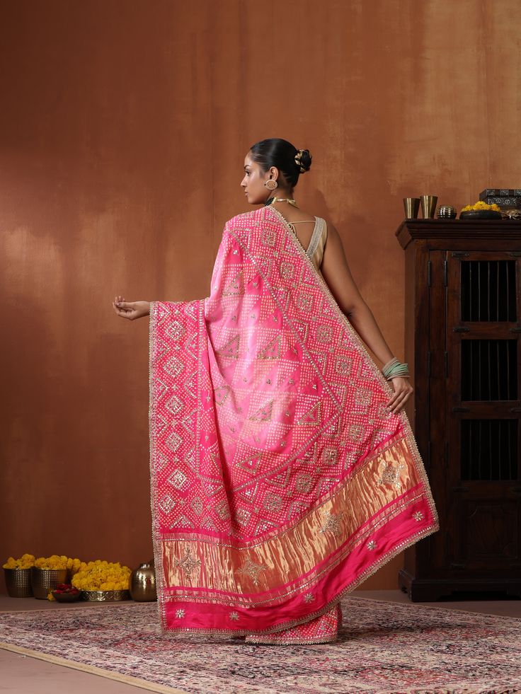 This Bandhani saree with Gotta Patti embroidery is a timeless masterpiece, blending traditional artistry with contemporary elegance. Crafted from pure Gajji silk in a striking red hue, it exudes grace and sophistication. Traditional Drape Anarkali Set With Zari Work, Traditional Designer Pre-draped Saree For Navratri, Festive Pre-draped Saree For Traditional Ceremonies, Bollywood Style Tussar Silk Pre-draped Saree With Motifs, Anarkali Style Cutdana Dupatta In Traditional Drape, Festive Katan Silk Pre-draped Saree With Dupatta, Traditional Pre-draped Saree With Cutdana For Festivals, Transitional Pre-draped Saree With Cutdana For Traditional Ceremonies, Red Bandhani Print Designer Saree