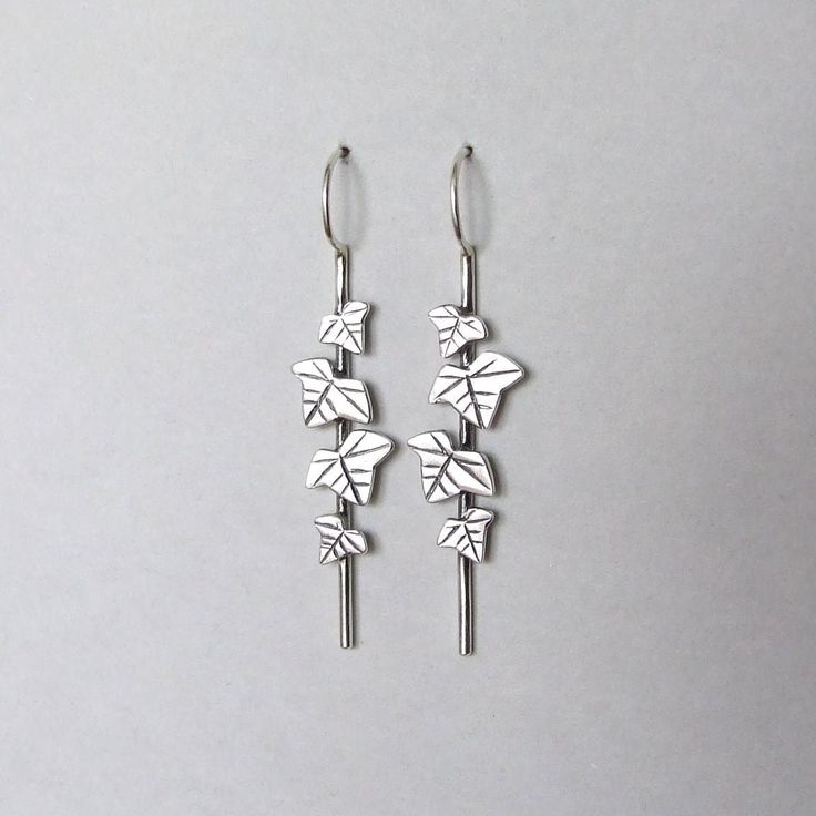 These beautiful dangle earrings are inspired by ivy leaves on a stem. They are impressive and are great to wear as wedding jewelry or for other special occasions. You can order them made of sterling silver or gold-plated silver with a nice matte finish. Each earring is 1.95 inches ( 5 cm ) long including the ear hoops, and the widest leaf is 0.39 inches ( 1 cm ). These earrings are "made to order" and take 2 - 4 weeks to make. Leaf Earrings Silver, Woodland Earrings, Leaves Earrings, Ivy Leaves, Gold Dangle Earrings, Ivy Leaf, Silver Dangle Earrings, Woodland Wedding, Etsy Earrings Dangle