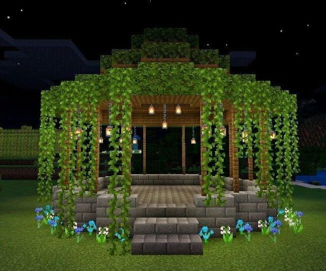 an outdoor gazebo with steps and flowers on the ground at night in minecraft