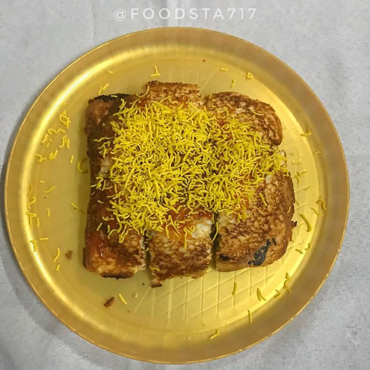 a yellow plate topped with meat covered in cheese