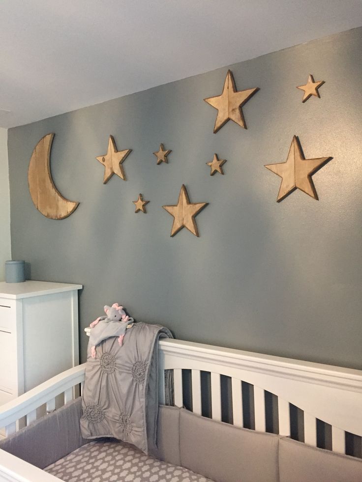 a baby's room with stars and moon decorations on the wall