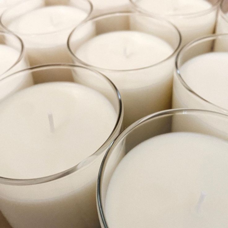 many white candles are lined up in rows