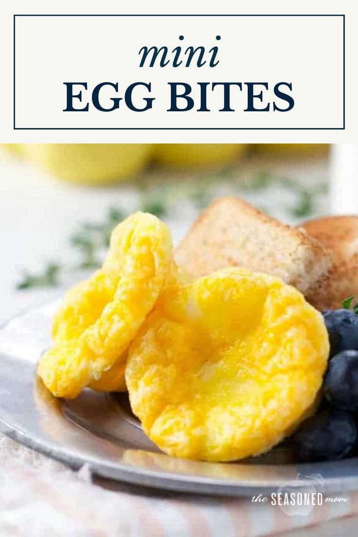 an egg bites on a plate with blueberries and bread in the background text reads, mini egg bites