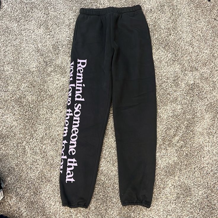 Super Comfy Sweatpants. Charcoal/Black Color And Purple Lettering Of “Remind Someone That You Love Them Today” Never Worn And New With Tags. From Nordstrom Size: Extra Small Black Graphic Print Loungewear Pants, Spring Black Sweatpants With Letter Print, Black High Waist Bottoms With Letter Print, Black Letter Print Bottoms For Spring, High Waist Black Bottoms With Letter Print, Fitted Black Bottoms With Graphic Print, Black Bottoms With Letter Print For Spring, Black High-waist Bottoms With Letter Print, Black Letter Print Long Pants