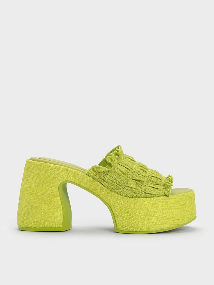 No summer wardrobe is complete without a pair of statement sandals. Made in an eye-popping lime-green that will brighten up your look, these sandals are an effortless way to spruce up a simple outfit. The sculptural 10cm platform heels also take these shoes to greater style heights without compromising on walkability. Pair them with a cut-out jumpsuit and bucket bag for an ultra-cool beach look. Summer Beach Sandals With Padded Heel, Green High Heel Mules For Summer, Summer Green Open Heel Mules, Green Open Toe Mules For Spring, Green Open Heel Mules For Summer, Summer Sandals With Padded Heel, Green High Heel Sandals For The Beach, Green High Heel Sandals For Spring, Green Platform Sandals For Spring